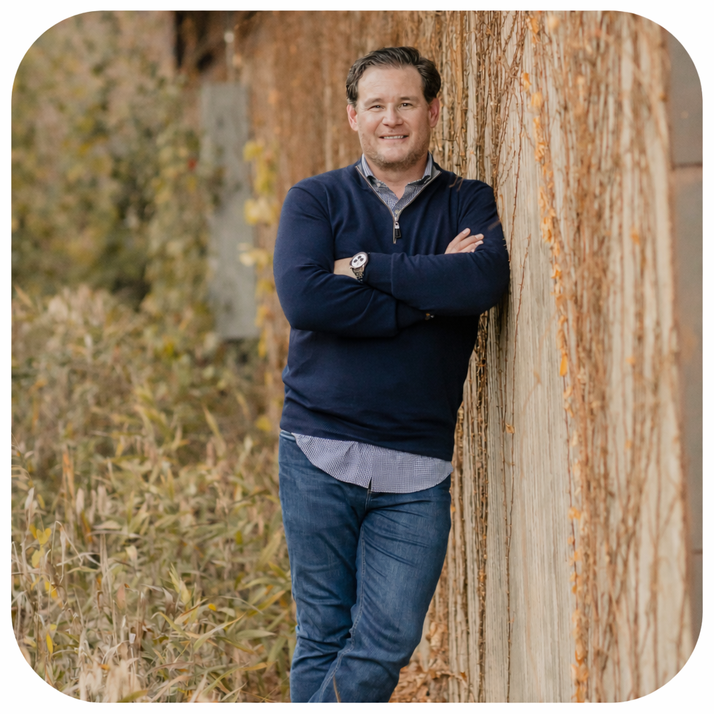 Smiling man in casual attire outdoors